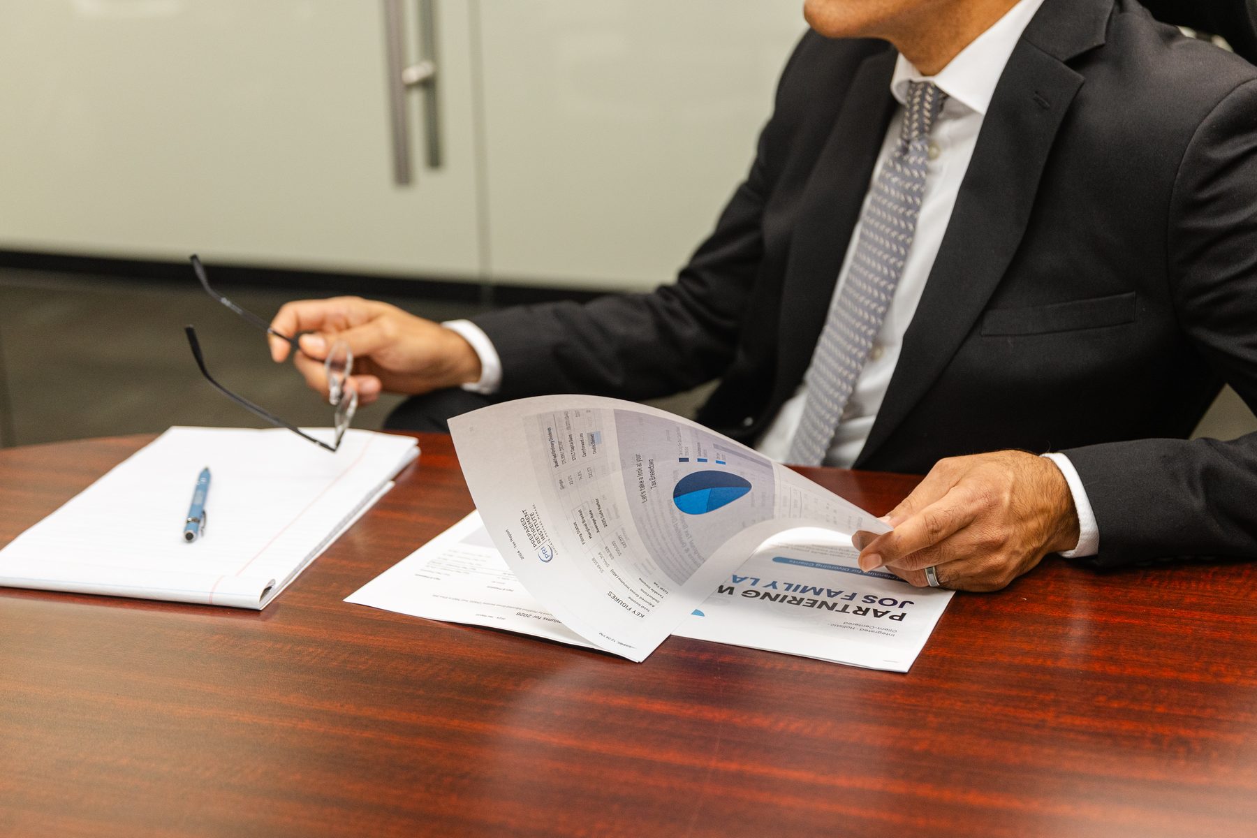 Jos Family Law attorney reviewing case documents and financial breakdown at the conference table